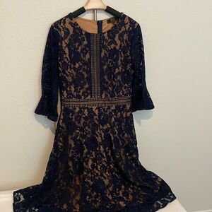 Navy blue lace dress with trumpet sleeves.